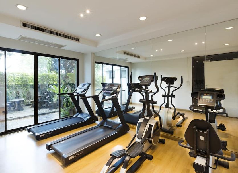 Asia Hotels Group (Poonpetch Chiangmai) gym in Chiang Mai with treadmills, ellipticals and mirrored wall
