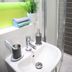 Aparto Dorset Point City Centre Accommodation, Dublin: compact bathroom sink with shower and toiletries