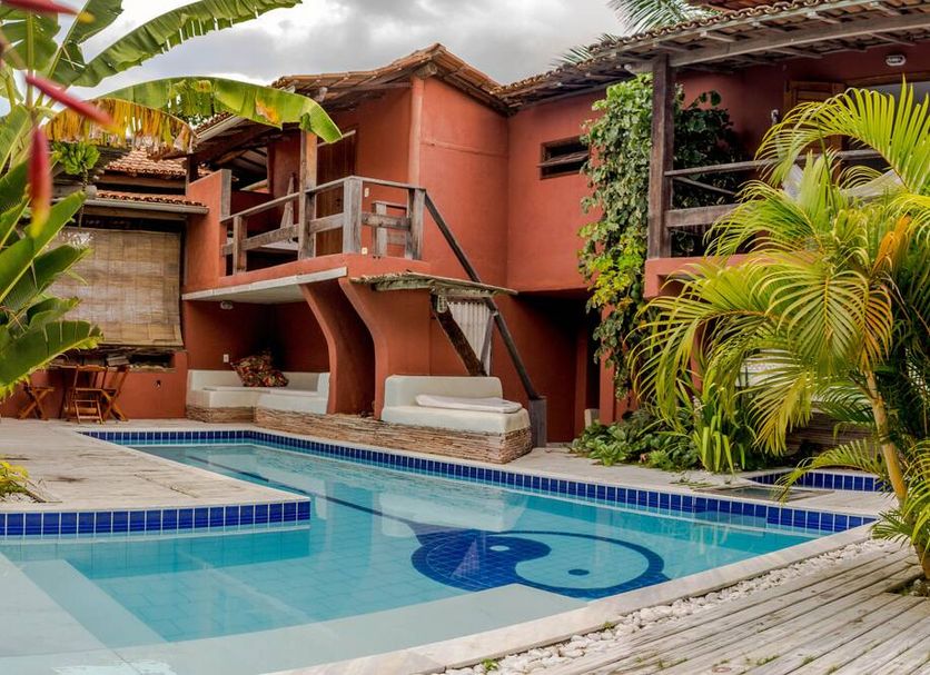 Pousada Aiuruoca in Caraiva with outdoor pool, tropical landscaping and wooden balconies