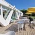 Hôtel Saint-Clair, côté Plage in La Grande-Motte with outdoor terrace, yellow umbrellas and garden view
