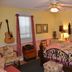 The Garden Walk Bed & Breakfast in Lookout Mountain bedroom with ornate wrought-iron bed, guitar, and window