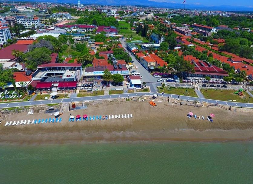 Clover Magic Altinkum Park Hotel in Side, aerial view of beachfront and nearby red-roofed buildings