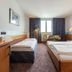 enjoyHotel garni Korntal Stuttgart room with twin beds, desk and window in Korntal-Münchingen