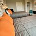 The 409 Bolivar Beach Hotel room with two beds, wall-mounted TV and small desk in Bolivar Peninsula