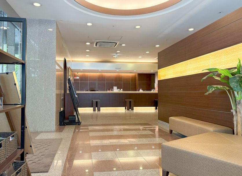 Hotel Route Inn Hakata Ekimae lobby in Fukuoka with seating, reception desk and polished tile floor