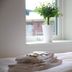 Flygplatshotellet in Härryda: neatly made bed with folded towels and a potted plant by the window