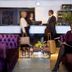 Vinger Hotell in Kongsvinger lobby with purple velvet seating and guests at the reception desk