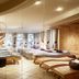 Tirolerhof in Ehrwald spa relaxation room with wooden loungers and large windows