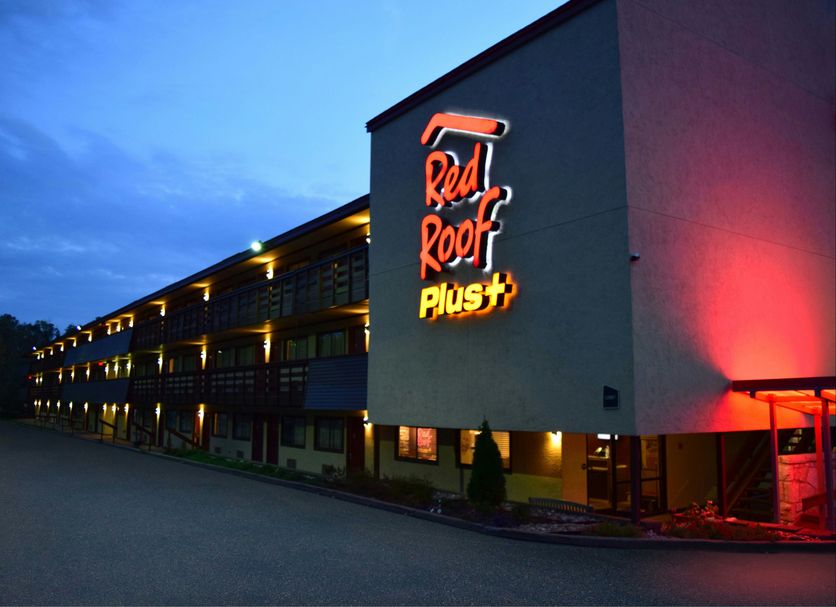 Red Roof Plus+ Pittsburgh East - Monroeville exterior at dusk with illuminated sign