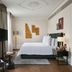 Rosewood Vienna guest room with king bed, large windows, and modern wall art in Vienna
