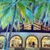 Hotel Tesoro Beach in La Herradura under palm trees with arched windows and lit interior