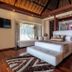 Seven Secrets by Hanging Gardens in Senggigi: luxury bedroom with king bed, lounge chair, and wood ceiling