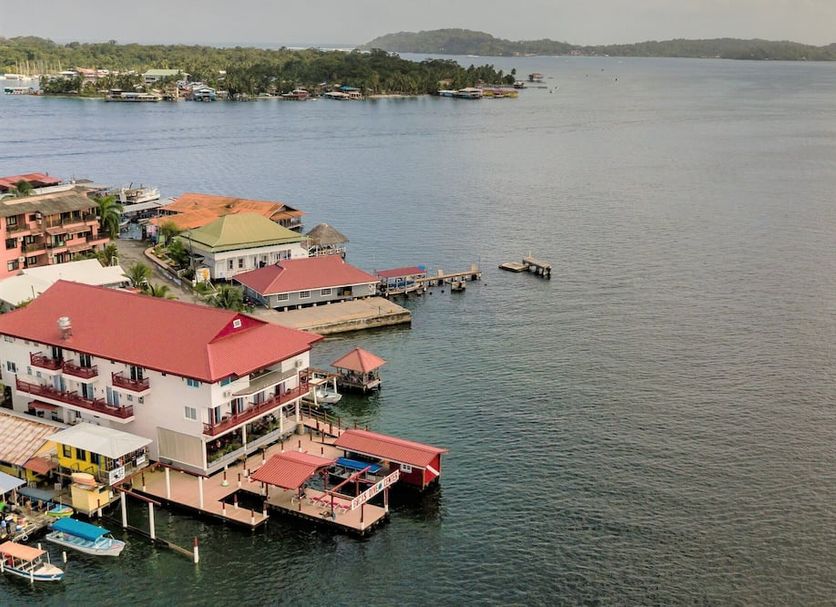Divers Paradise Boutique Hotel in Bocas del Toro overlooking calm waterfront with docks and boats