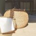 Hotell Björkhaga in Mullsjö: woven wicker baskets with a folded white towel on a sunlit floor