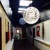 Westside Studio Apartments in Armidale hallway with hanging globe lights and framed wall art