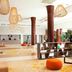 Paris Marriott Charles De Gaulle Airport Hotel lobby in Roissy-en-France with tall wooden columns and lounge seating