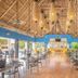 Royal Decameron Salinitas in Acajutla: open-air restaurant with thatched ceiling, hanging lights and tables