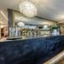 Hotel Ristorante La Rosina in Marostica bar area with long counter, hanging lights and mirrored back wall
