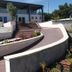 Agriturismo Vivinatura in Gallipoli with curved terrace walkway, flower planters and modern building exterior