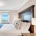Newport Beach Hotel & Suites room in Middletown with ocean view through window, king bed and TV