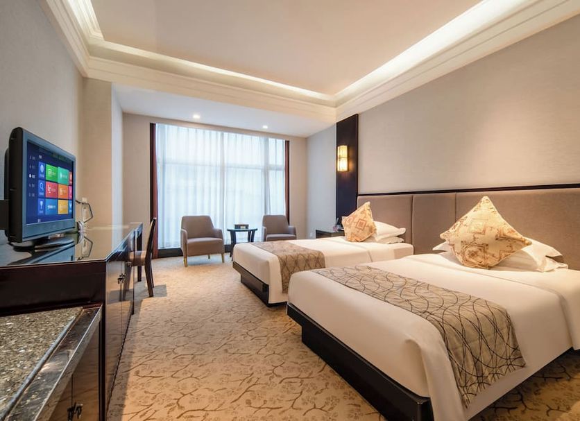 Redstar Culture Hotel Hangzhou room with two twin beds, seating area, and window view