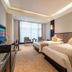 Redstar Culture Hotel Hangzhou room with two twin beds, seating area, and window view