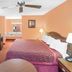 Americas Best Value Inn Kosciusko guest room with king bed, TV, desk and dresser
