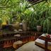 Lynnaya Urban River Resort in Siem Reap, lush tropical garden pond with stone steps and seating