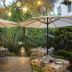 Riad Jardin Des Biehn garden dining terrace in Fez with tables, umbrellas and lantern lighting