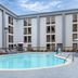 Spark by Hilton Atlanta Airport South College Park pool deck with lounge chairs and umbrellas in College Park