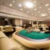 Jeju Sun Hotel & Casino in Jeju City features a casino floor with gaming tables and cream seating
