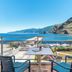 Aqua Natura Bay Porto Moniz balcony with chairs and table overlooking ocean and mountains