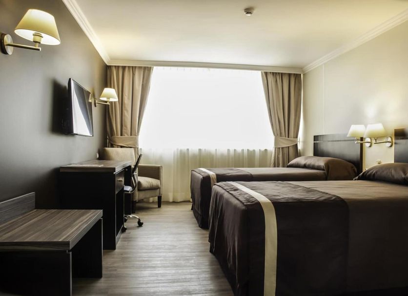 Hotel Diego de Almagro La Serena guest room with two beds and a large window