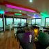 Tharangini Houseboats in Alappuzha dining area with colorful ceiling lights and sea views