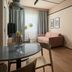 Sky Hotel Apartments Stockholm living room with sofa, dining table, kitchen and large window
