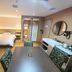 Wuyue Yuexin Hotel (Jinggangshan) room with bed, dining table, bathroom, and sitting area in Ji'an