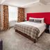 Newton Country Hotel Burton room in Burton upon Trent with double bed, patterned sofa and floral curtains