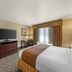 Best Western PLUS Truckee-Tahoe Hotel room with king bed, TV, desk and window curtains in Truckee