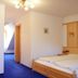 Zu den Linden Nichtraucherhotel in Aschheim, double bed room with blue carpet and wall art