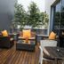 Hotel Santiago in Praia patio with wooden deck, seating area, potted plants and a glass door