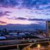 Hilton Bogota Corferias in Bogotá at dusk, with lit windows and city skyline under a colorful sky