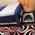 Divine Villa and Resorts in Newark guest room with bed, patterned rug, bedside table and curtain