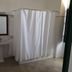 Monte Dos Apóstolos in Portalegre: simple bathroom with pedestal sink, mirror, and white shower curtain