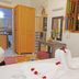 Riad Zanouba in Marrakech guest room with towel swans, carved wardrobe, and bathroom doorway