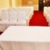 Austral Bahia Blanca Hotel in Bahía Blanca with rows of white-covered chairs and a red-carpeted event room