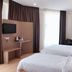 Tumike Hotel Bentong guest room with two twin beds, TV, desk, and bright window