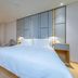 Ji Hotel Shenzhen Shennan Avenue Huaqiang guest room with king bed, armchair, and abstract wall art in Shenzhen