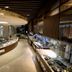 Novotel Ambassador Suwon buffet restaurant interior with curved food counters and glass displays