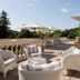 Domaine et Golf de Vaugouard - La Maison Younan terrace with wicker seating and umbrellas in Fontenay-sur-Loing