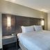 Residence Inn by Marriott Providence Lincoln guest room with king bed and bedside lamps